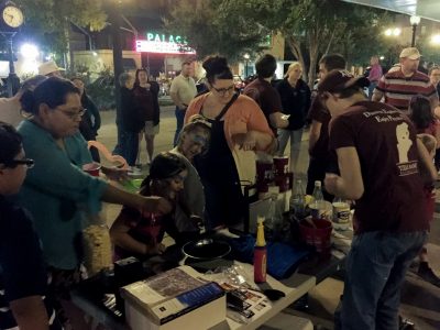 Families passing by the physics booth in Downtown, Bryan.