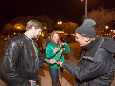 People demonstrating center of gravity using a sky hook and belt.